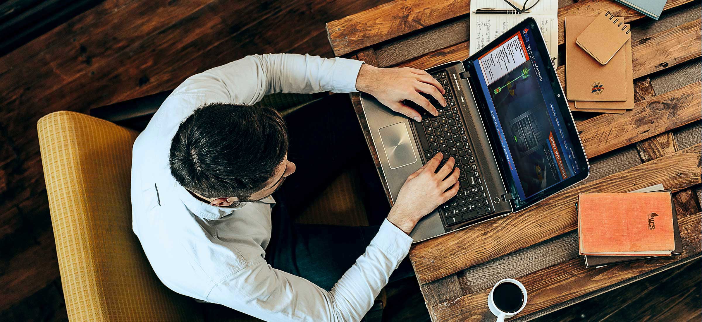 A man taking an e-Learning well control class on his laptop